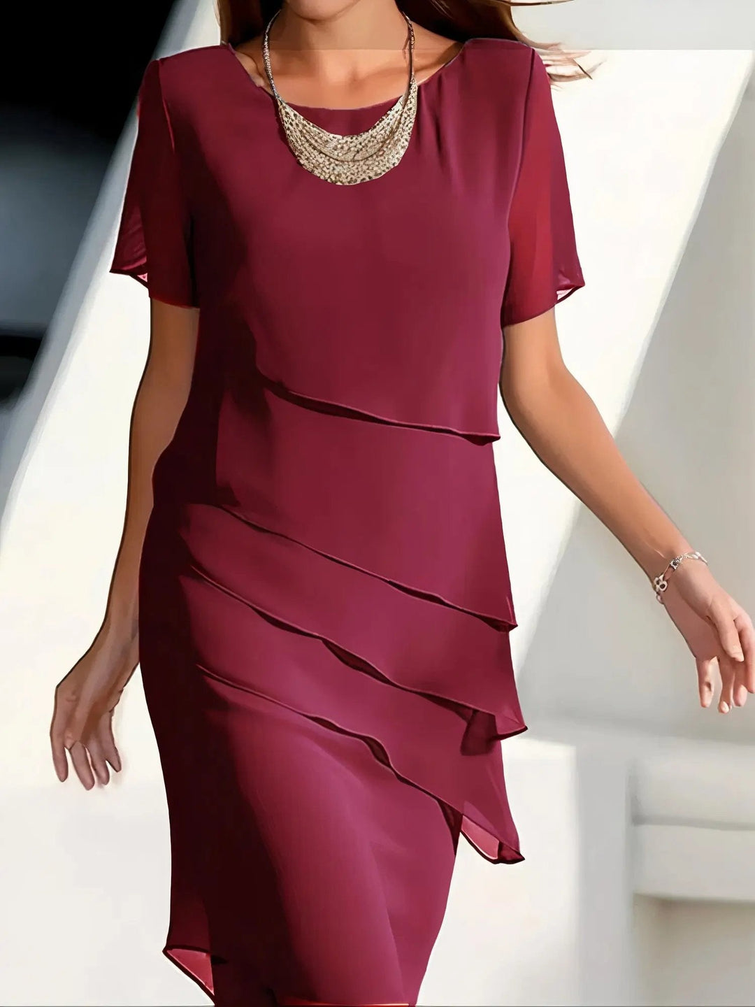 Women's tiered flowing midi dress. Relaxed fit, round neck, short sleeves. Elegant and versatile for casual or formal style.