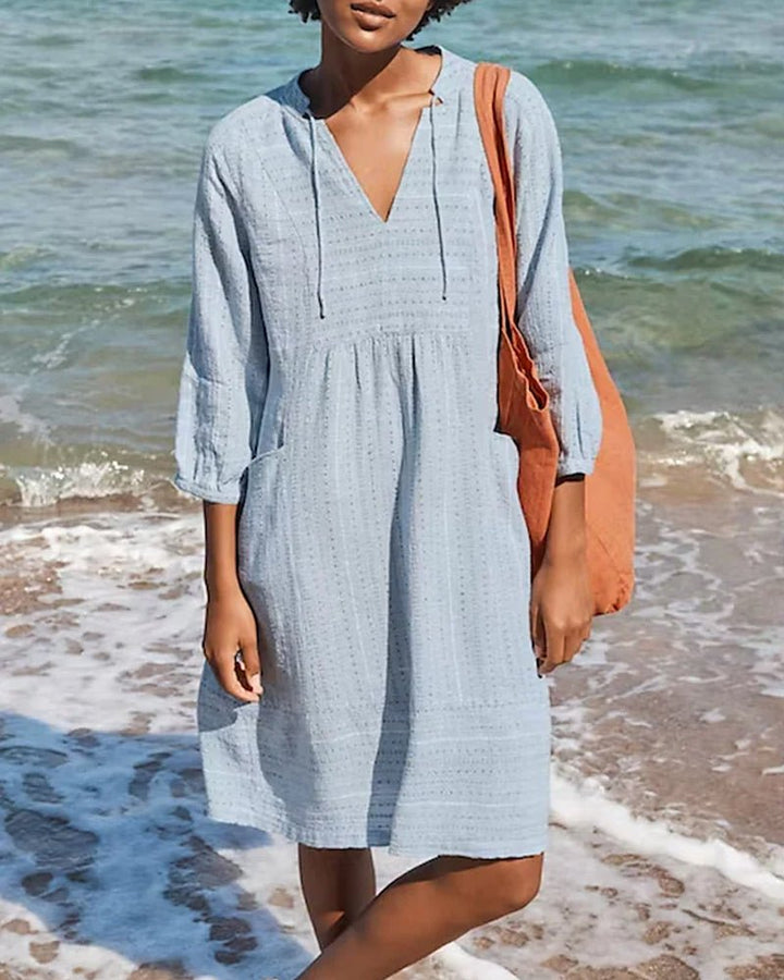 Women's V-neck bohemian summer midi dress. Flowing, relaxed fit ideal for casual wear, beach, or vacation.