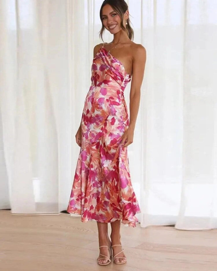 Women's vibrant floral asymmetric midi dress with a flowing hem, perfect for summer parties.