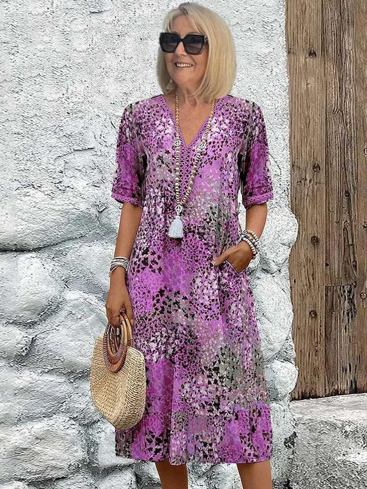 Vibrant print women's midi dress with flowy design. Perfect versatile attire for casual days or elegant parties.