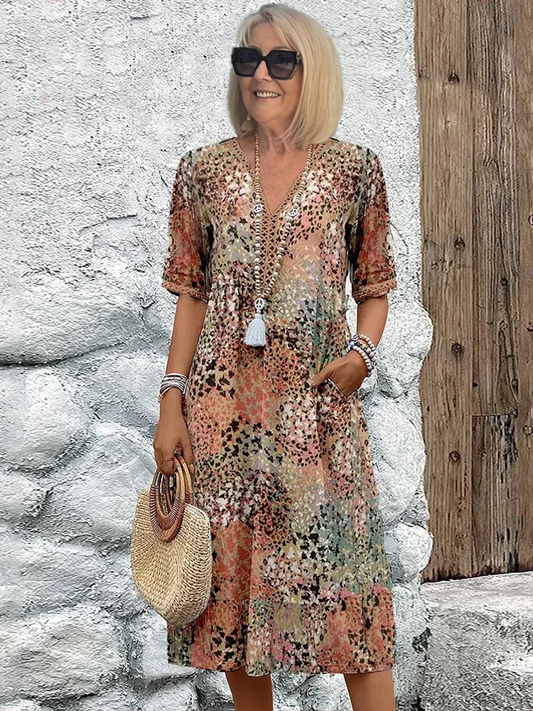 Stylish women's vibrant print midi dress with a comfortable flowy design. Features pockets; great for summer parties.