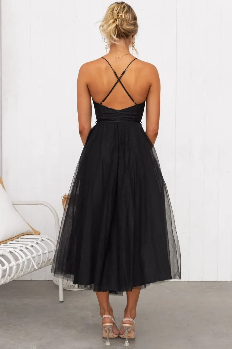 Formal women's midi dress featuring a corset top, spaghetti straps & A-line skirt. Great for evening parties.