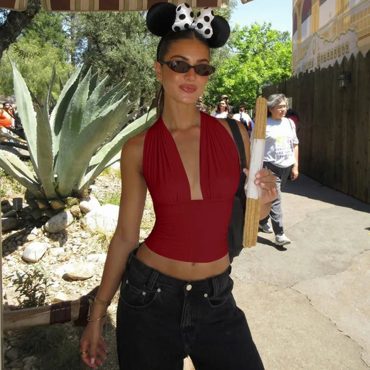 Stylish women's halter neck top with open back design. Perfect for a chic summer look or party wear. Adjustable.