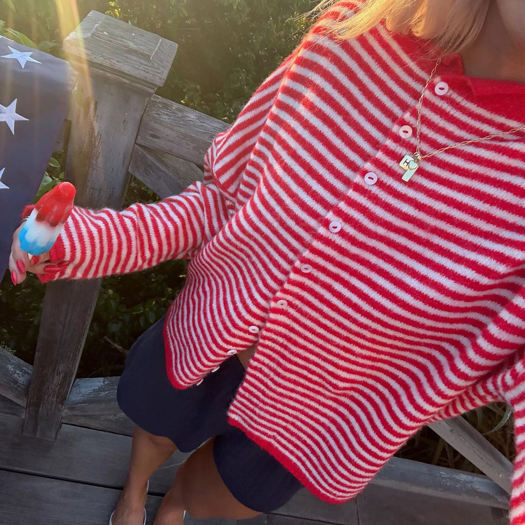 Elegant women's knitwear cardigan with a vibrant striped pattern and practical button detailing.