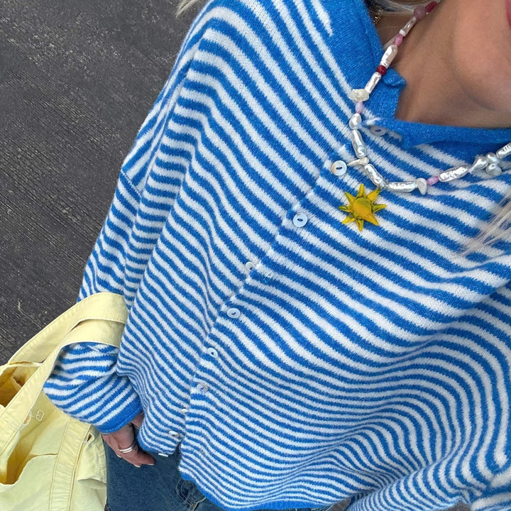 Everyday women's striped button-front top, offering a versatile and fashionable layering option.